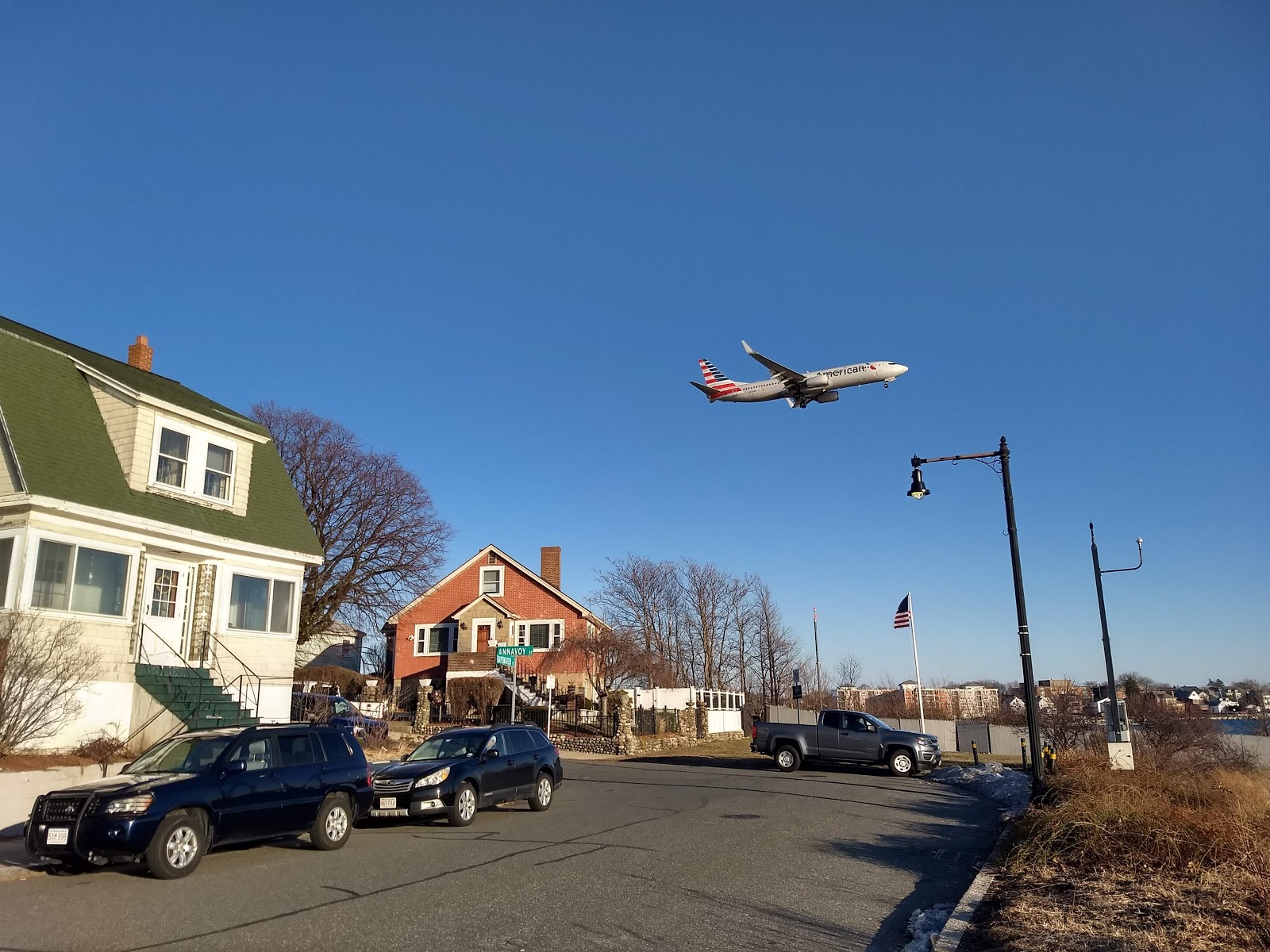 plane flying over a residential area in East Boston