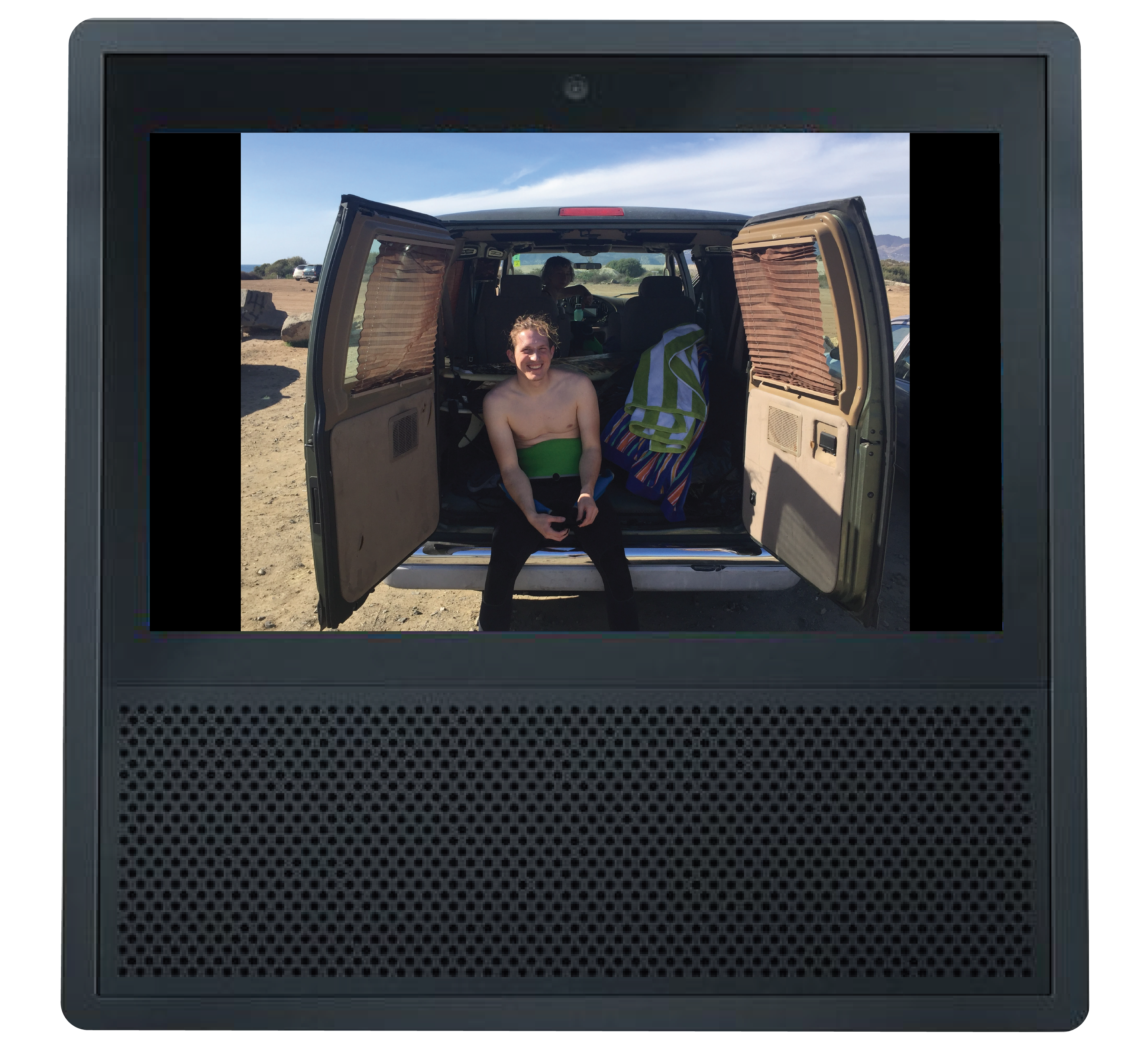 Echo show with image of man in wetsuit sitting in a van